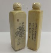 A pair of 20th century Japanese bone scent bottles with engraved decoration and script, one
