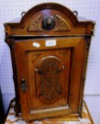 A small Victorian carved walnut wall cabinet with single panelled door