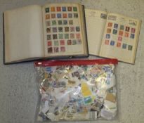Two mid 20th Century stamp albums containing various world stamps, together with a packet of loose