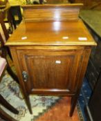 An Edwardian mahogany and inlaid pot cupboard, the single panelled door on square tapering legs