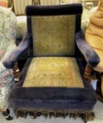 A Victorian walnut framed upholstered open armchair on turned front legs