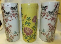 A pair of Chinese porcelain cylindrical vases decorated with birds amongst flowering branches,