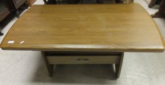 A modern oak effect adjustable coffee table with single drawer