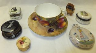 A Royal Worcester cabinet cup and saucer painted with fruit, the cup signed "H. Aynton", and the