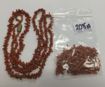 An early 20th century pink coral necklace, together with various beads