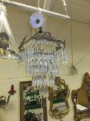 A four tier glass drop chandelier with brass frame and two boxes of various lights   CONDITION