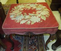 A Victorian rosewood framed dressing stool with floral needlework decorated seat above a shaped
