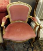 A French gilt framed fauteuil / salon chair with pink upholstered back and seat