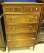 A mid 20th Century oak chest of two short over four long drawers with coppered ring handles in the