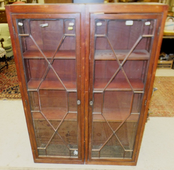 A pair of 19th century bookcases with astragal glazed doors enclosing shelves