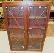 A pair of 19th century bookcases with astragal glazed doors enclosing shelves