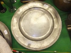 An 18th Century English pewter broad-rimmed charger with false hallmarks and London touch marks to