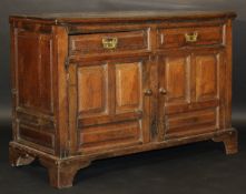 A late 18th Century oak dresser, the rectangular top with moulded edge over two drawers above a pair