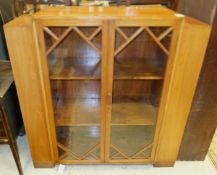 An Art Deco walnut cabinet in the manner of Betty Joel, the two glazed doors opening to reveal two