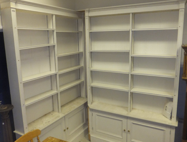 Two painted tall bookshelves with cupboards under