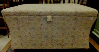 A circa 1900 upholstered box ottoman of waisted form