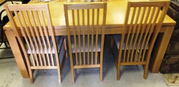 A modern oak rectangular dining table and set of six slat back dining chairs with upholstered seats