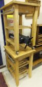 A pair of beech kitchen work trolleys with lower tiers and two camera tripods