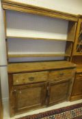 A Victorian pine dresser, the two tier open plate rack over a base of two drawers over two