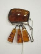 A white metal mounted amber set brooch, the white mounts stamped with Russian marks