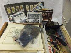 A box containing various cigarette and tea cards, a bag of assorted coinage, various black and white