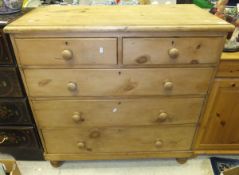 A late 19th / early 20th Century pine chest of two short over three long drawers, raised on bun feet