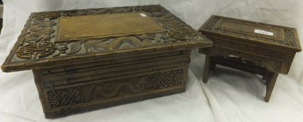 A late 19th Century Chinese rosewood work box with drop down supports, the lid decorated with