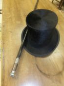 A silver topped ebonised evening cane with silver ferrule and a Dunn & Co. black silk top hat
