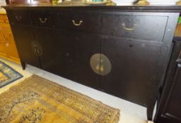A modern Oriental style ebonised sideboard of four drawers over four cupboard doors   CONDITION