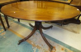 An early 19th Century mahogany breakfast table, the oval snap top on a splayed reeded quadruped base