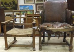 An oak Arts and Crafts low armchair with rush seat, together with an oak framed tub chair with brown
