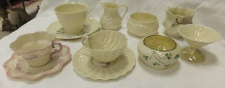 A collection of Belleek porcelain to include a shell shaped cup and saucer with black back stamp,
