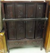 A Chinese stained soft wood cabinet with bar lock over two drawers