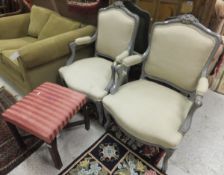 A pair of early 20th Century grey painted French fauteuilles / elbow chairs upholstered in an