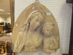 A terracotta wall hanging of Gothic Arch form decorated in high relief with the Madonna and infant