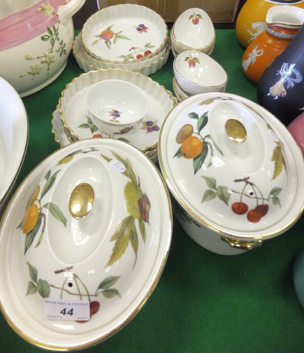A collection of Royal Worcester "Evesham" pattern table wares to include lidded tureens, quiche