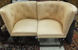 A pair of peach upholstered corner chairs with curved backs, raised on square tapering legs,