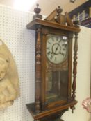 A 19th Century American walnut cased Vienna regulator style wall clock