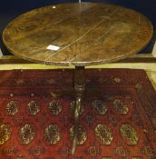 A 19th Century oak occasional table, the circular top on a turned pedestal to tripod base