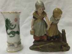 An Ernst Wahliss, Turn, Vienna porcelain figure group of two children wearing clogs and