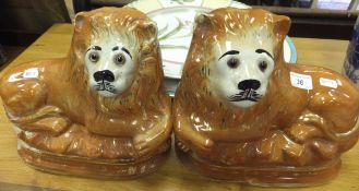 A pair of Sadler Burslem pottery figures of lions, together with a pottery charger and two meat