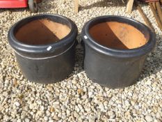 A pair of glazed terracotta circular garden planters