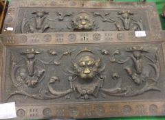 A pair of carved oak Gothic revival drawer fronts, the handles formed as lions' heads, together with