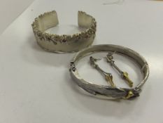A modern silver and stone set bangle stamped "Sterling 925", together with a further silver bangle