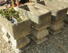 Three various reconstituted stone rectangular troughs on stands