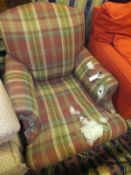 A 19th Century scroll armchair on turned and ringed front legs to castors, upholstered in tartan