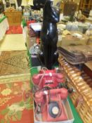 Two vintage red plastic emergency phones and a cat figure lamp