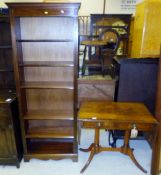 A mahogany six shelf open bookcase standing on bracket feet, and a mahogany reproduction sofa