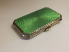 A George V silver and enamel engine turned decorated cigarette case, bears import marks for
