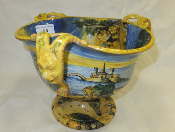 A Cantagalli majolica three handled bowl, raised on circular foot with Cupid and Classical landscape